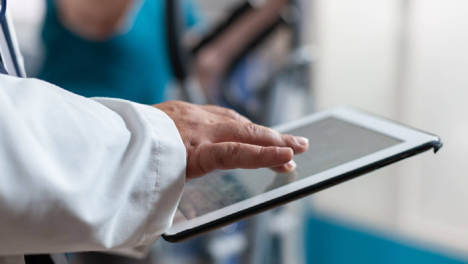 Doctor analyzing patient wearable data on tablet